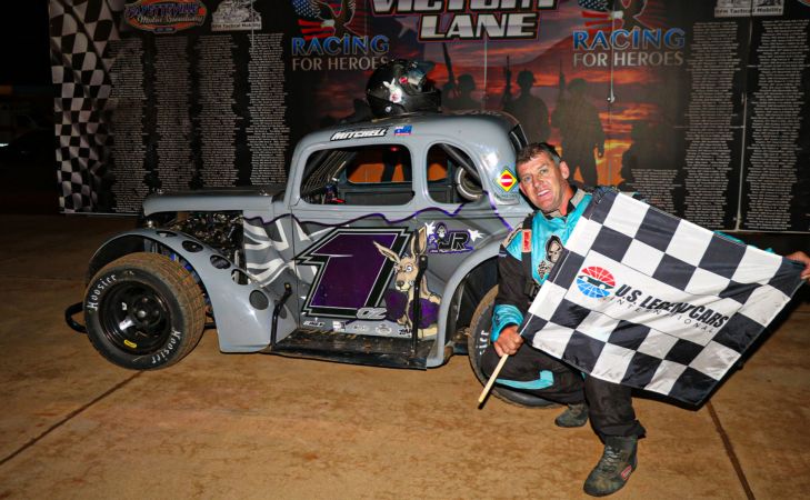 Glenn Mitchell poses in Fayetteville Motor Speedway victory lane after winning his first Legend Car Dirt Nationals Championship Feature on Saturday.