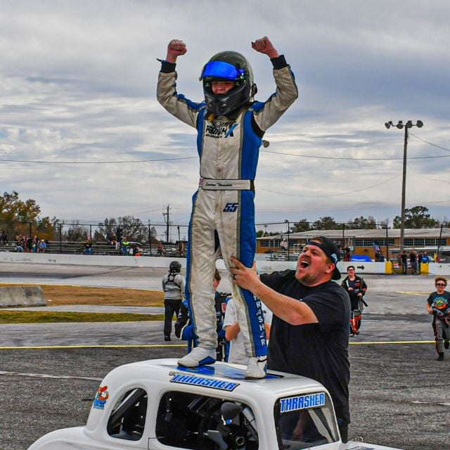 Landon Thrasher stands on top of his Legend Car following a Young Lions victory on Wednesday.