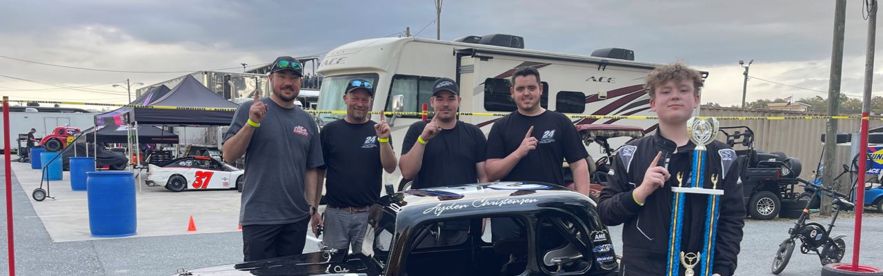 Ayden Christensen celebrating with his crew after winning the Round 1 Semi-Pro race during the 2024 Winter Nationals at Citrus County Speedway.