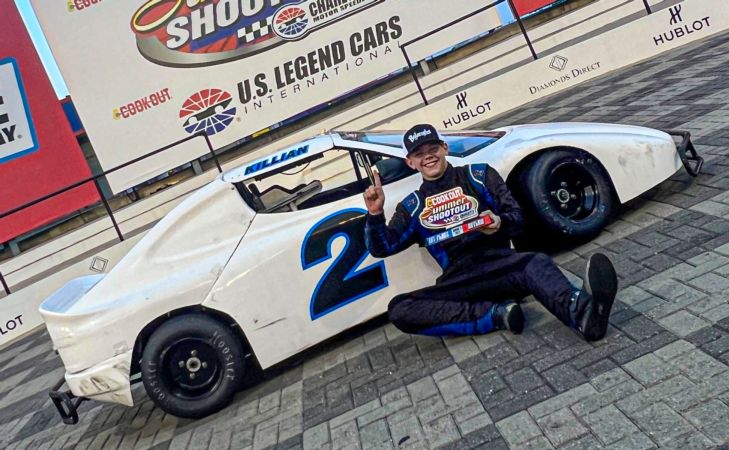 Killian McMann poses in Charlotte Motor Speedway victory lane after winning the Round 6 2023 Cook Out Summer Shootout Outlaws feature.