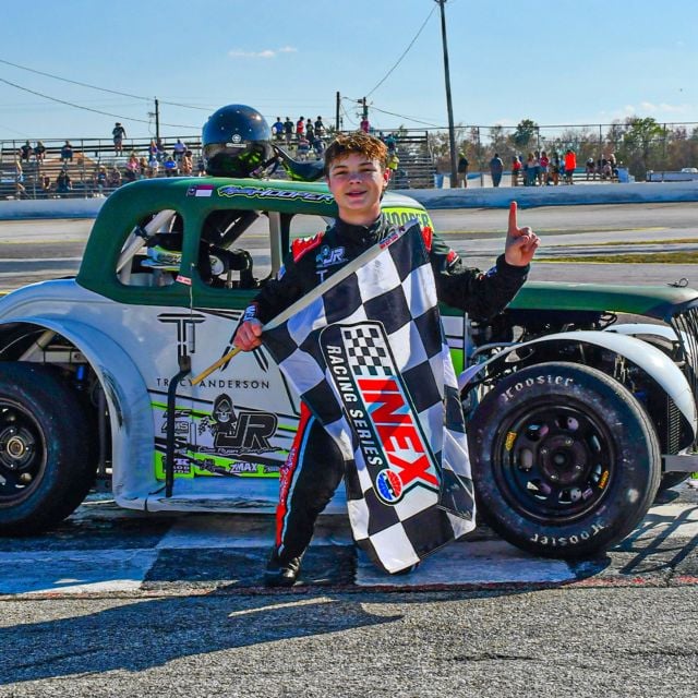After winning the fifth round of the 2026 INEX Winter Nationals, Maddox Hooper gets his winner's picture next to his Legend Car. 