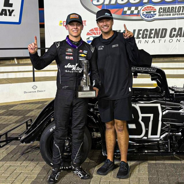 Davis Rochester (right) stands next to Danny Chisholm in Charlotte Motor Speedway victory lane after a win during the 2025 Cook Out Summer Shootout. 