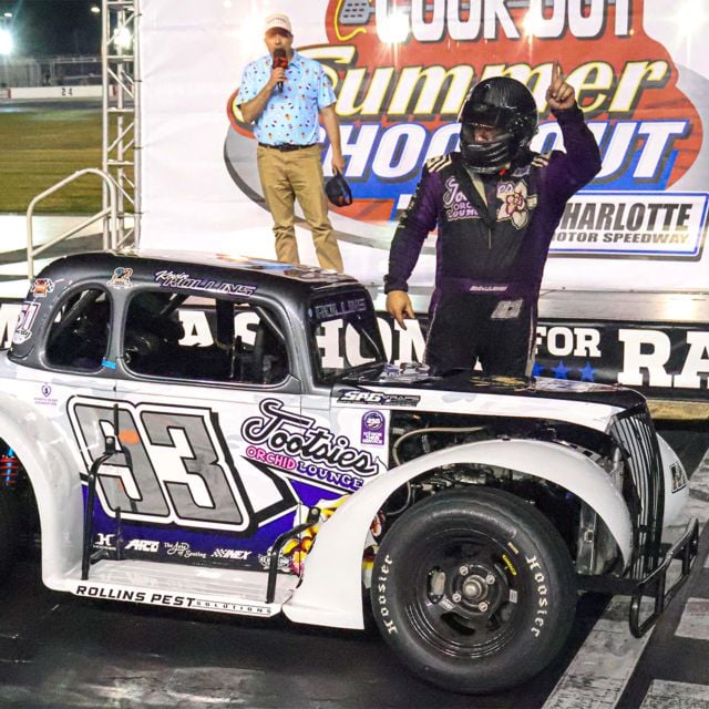Kevin Rollins next to Cook Out Summer Shootout victory stage after winning in Round 6. 